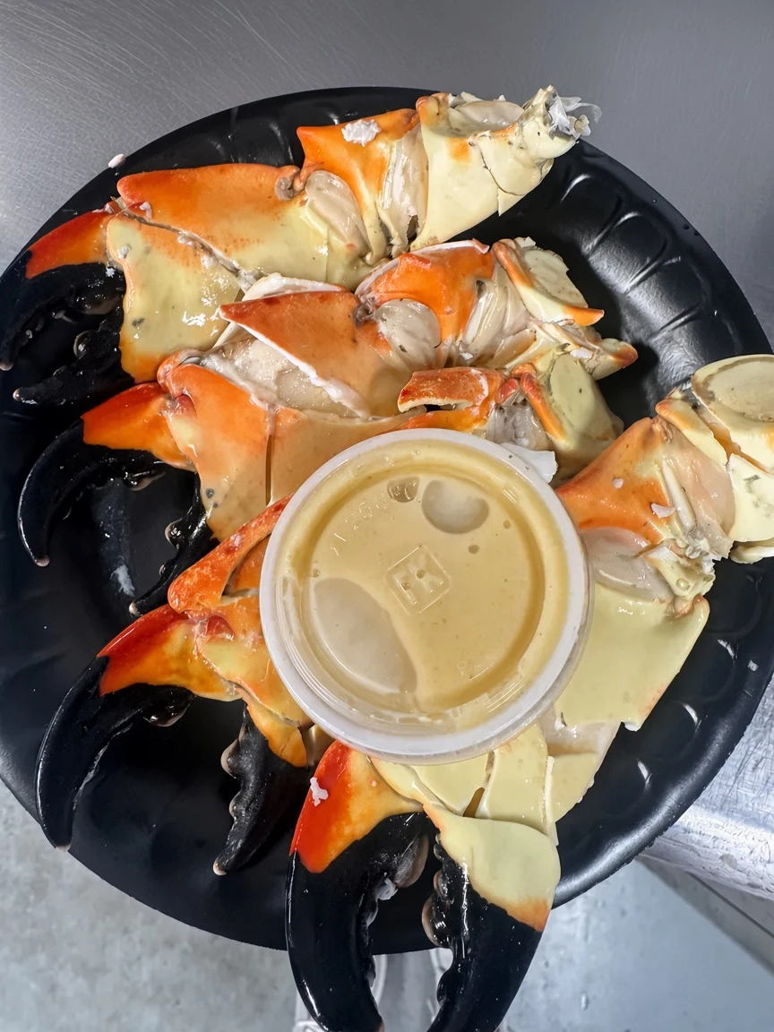 A platter of stone crab claws with dipping sauce