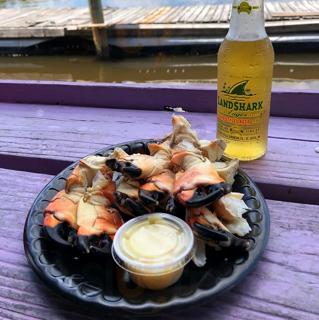 A plate of stone crab claws with mustard sauce on the dock at City Seafood
